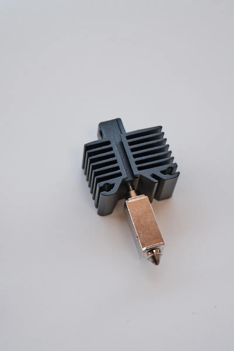 Close-up of a Bambu Lab 0.6mm hardened steel hotend assembly showing the black radiator fins and the precision nozzle tip.
