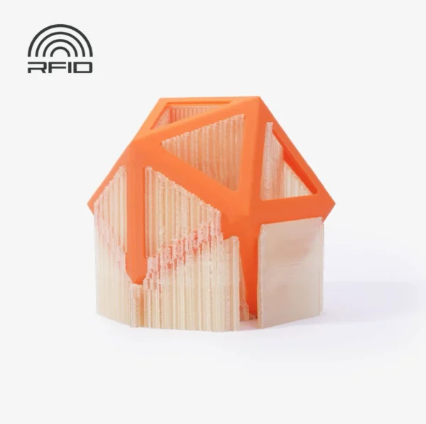 3D printed geometric model in orange filament with semi-transparent Bambu Lab Clear PVA support structures and an RFID technology icon.