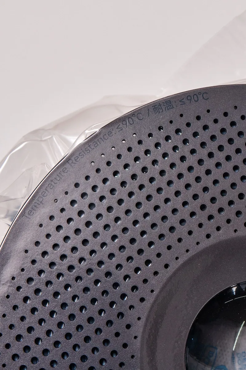 Close-up of a Bambu Lab filament spool edge showing the embossed "Temperature Resistance: < 90&deg;C/耐温: < 90&deg;C"specification in English and Chinese.