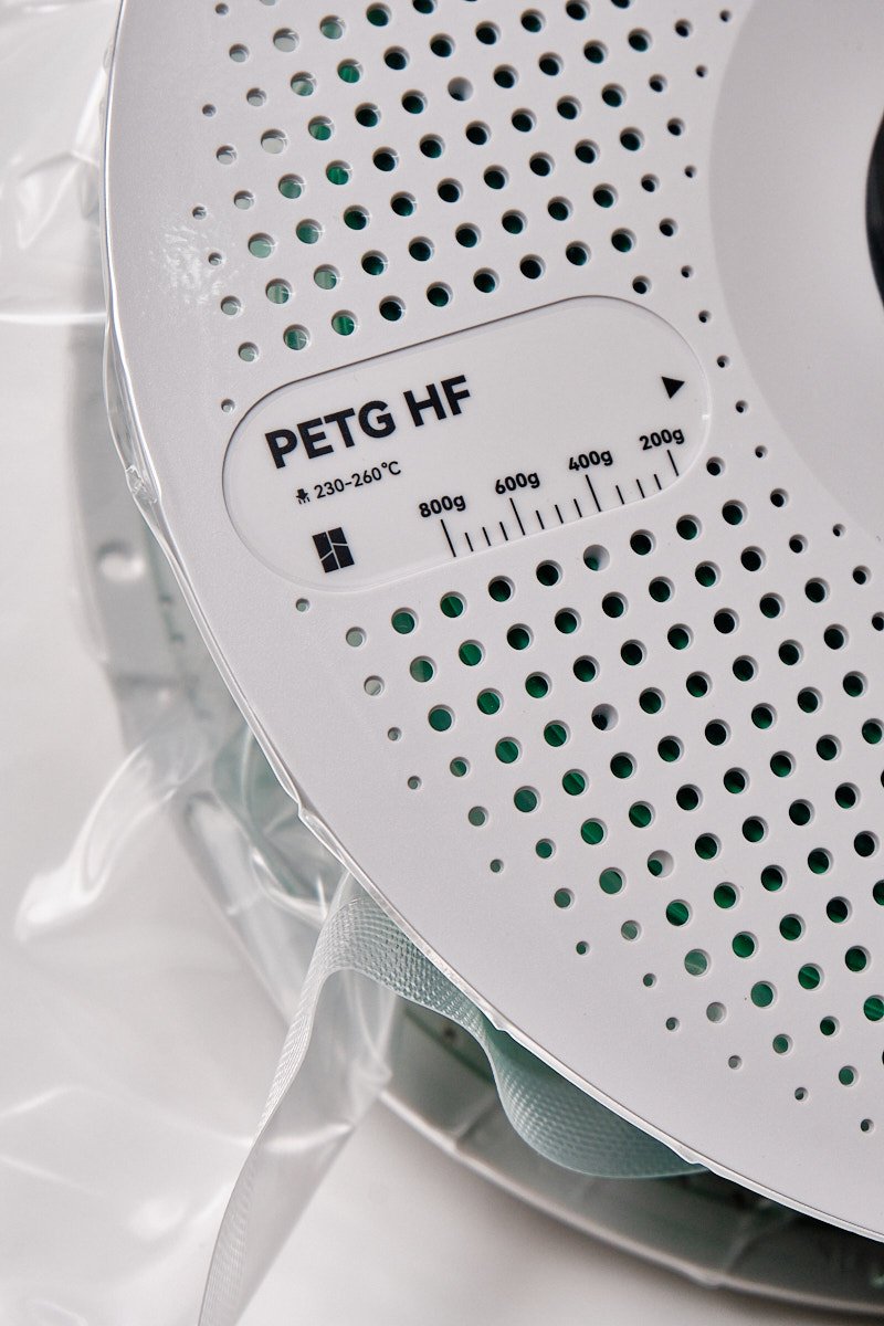 Close-up of the Bambu Lab PETG-HF Green label showing 230-260&deg;C print temperature and weight scale.