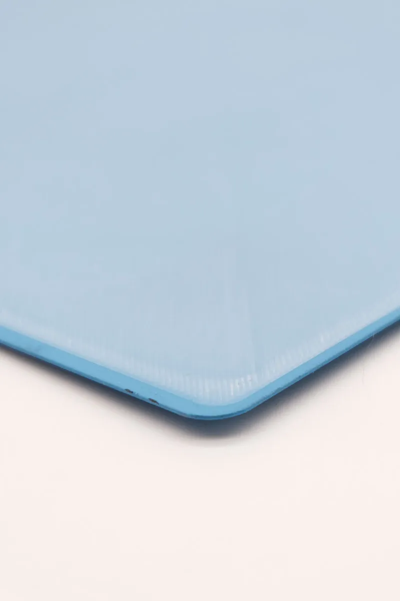 Close-up of blue cold build plate short edge center with transparent first-layer film perfectly adhering without curling.