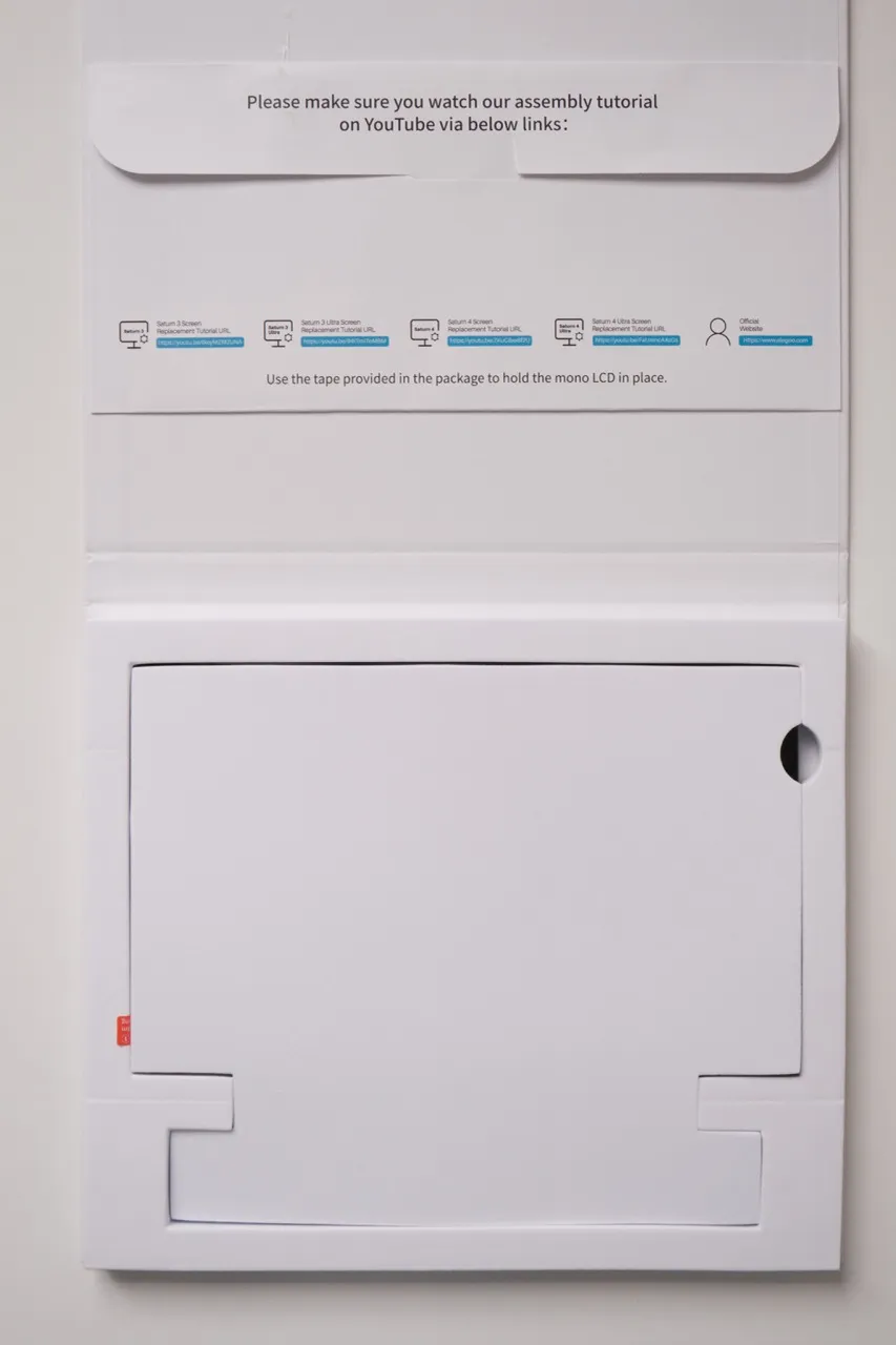 Elegoo Monochrome 12K LCD screen for Saturn 4 / 4 Ultra, showing printed user instructions on the box and LCD screen protected by white cardboard
