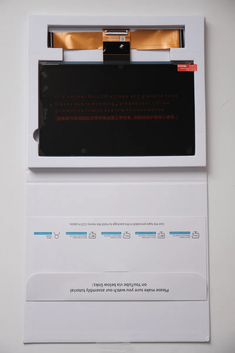 Elegoo Monochrome 12K LCD replacement screen for Saturn 4 / 4 Ultra, top-down view showing screen, ribbon cable, and user manual