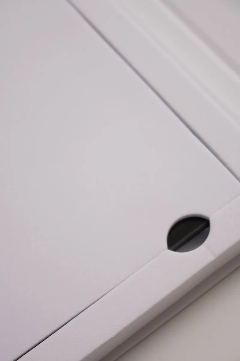 Close-up of the white protective cardboard inside the Elegoo Monochrome 12K LCD screen box for Saturn 3 / 3 Ultra, showing the opening hole used to lift the screen safely
