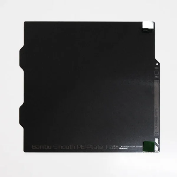 FAP008 Bambu Smooth PEI Build Plate – Top View with Protective Film Marker Top-down view of the FAP008 Bambu smooth PEI build plate showing the green peel-off protective film marker in the top-right corner