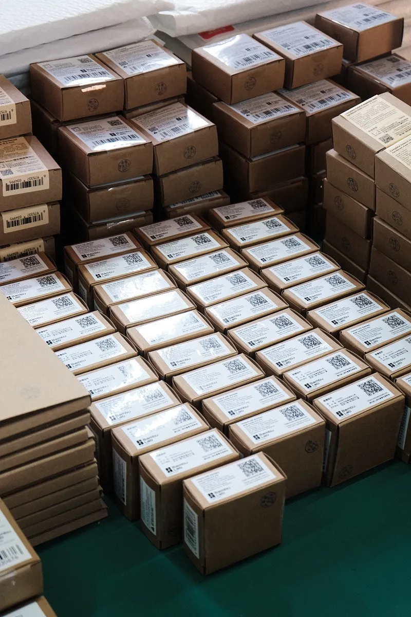 Individually packaged 3D printer hotend components arranged on a worktable, with labeled boxes facing upward