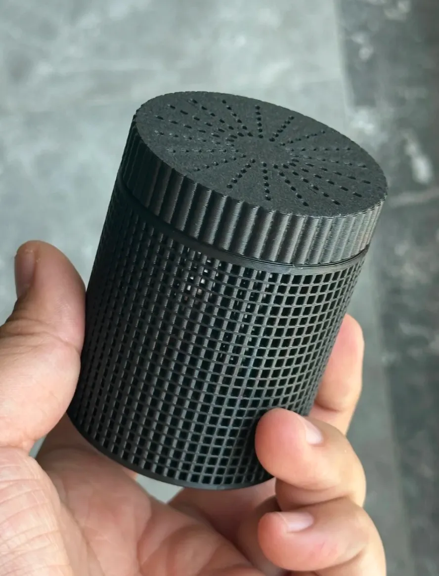 Bambu Lab PLA Basic Black filament 3D printed cylindrical object with grid pattern held in hand