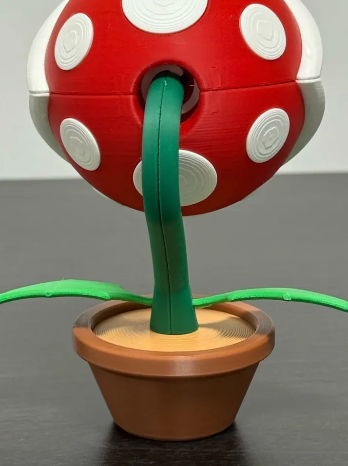 Bambu PLA Basic Brown filament 3D printed plant pot model with red and green printed parts