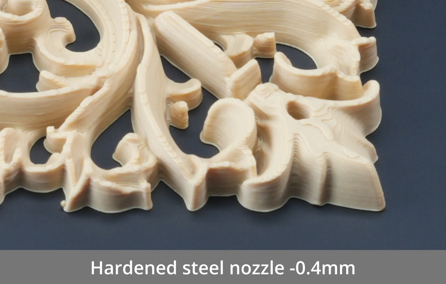 Close-up of a 3D printed part produced with a standard 0.4mm hardened steel nozzle, showing layer lines and extrusion limitations