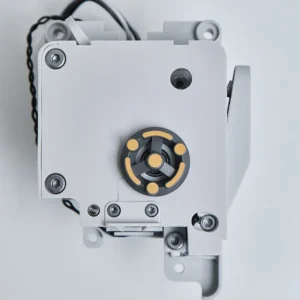 Detailed view of the Bambu Lab A1 series extruder unit showing the gray housing and yellow indicator gear