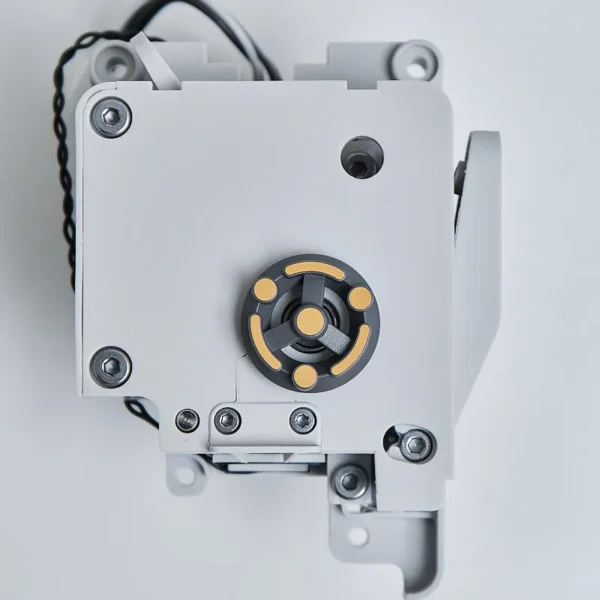 Detailed view of the Bambu Lab A1 series extruder unit showing the gray housing and yellow indicator gear
