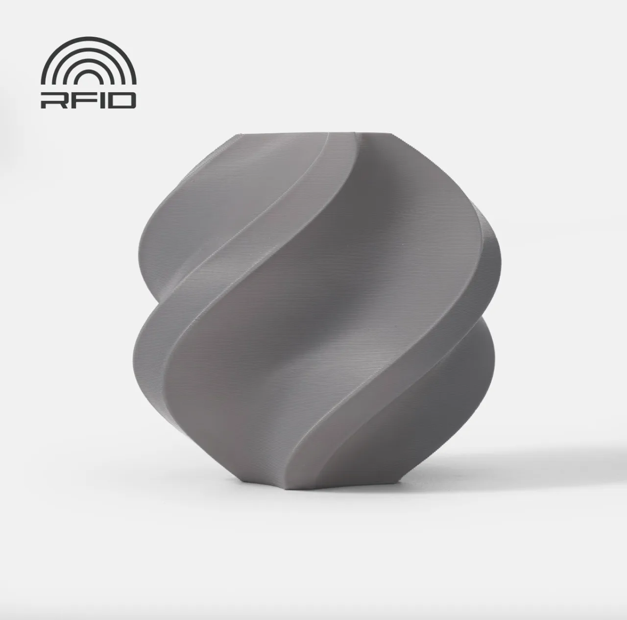 A 3D printed twisted geometric vase made with Bambu Lab ASA Gray 1.75mm filament, featuring a smooth matte finish and distinct layer lines.