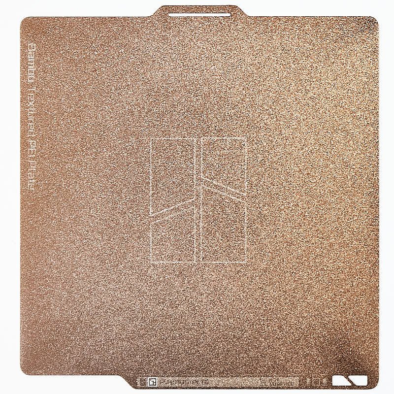 Full top-down view of the FAP007 256x256mm flexible magnetic textured PEI plate featuring the central Bambu logo and edge branding for X1 and P1 series.