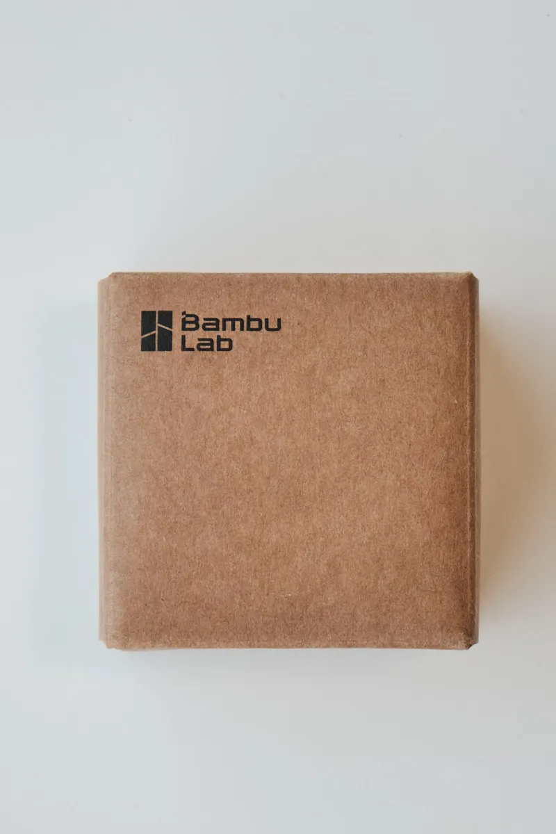 Original Bambu Lab brown cardboard packaging with official logo for replacement 3D printer parts.