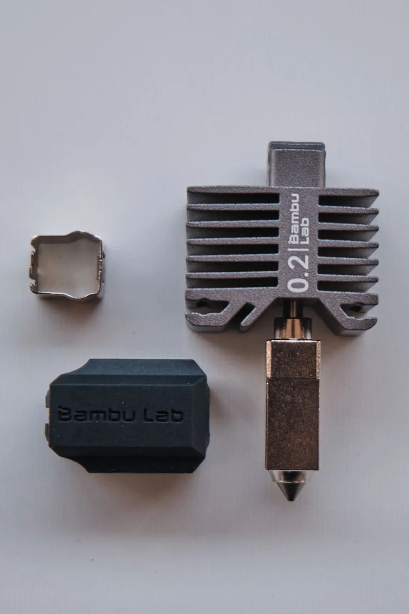 Close-up of Bambu Lab P1 series hotend featuring 0.2mm stainless steel nozzle and protective silicone sock