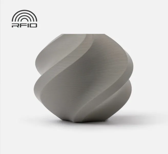 A 3D printed spiral geometric vase model made with Bambu Lab Gray PLA Basic filament, featuring a smooth matte-satin finish and an RFID logo in the top corner.