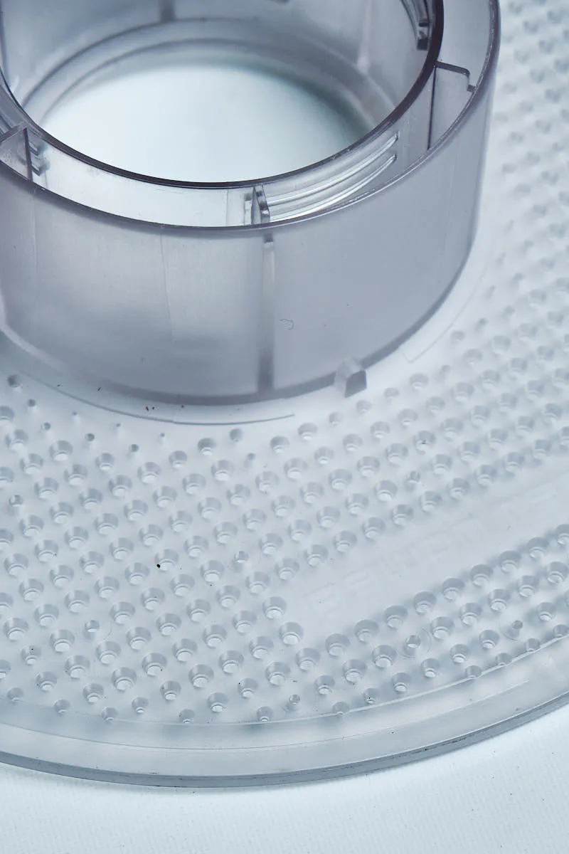 Close-up of an empty Bambu Lab transparent reusable spool for 3D printer filament refills, showing the inner hub structure.