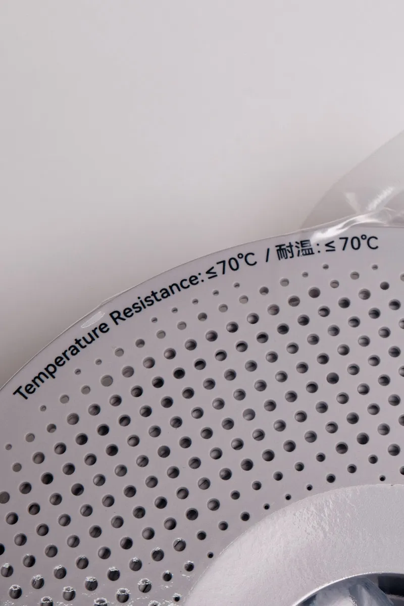 Close-up of a white Bambu Lab reusable spool edge showing the text "Temperature Resistance: &le;70&deg;C" in English and Chinese.
