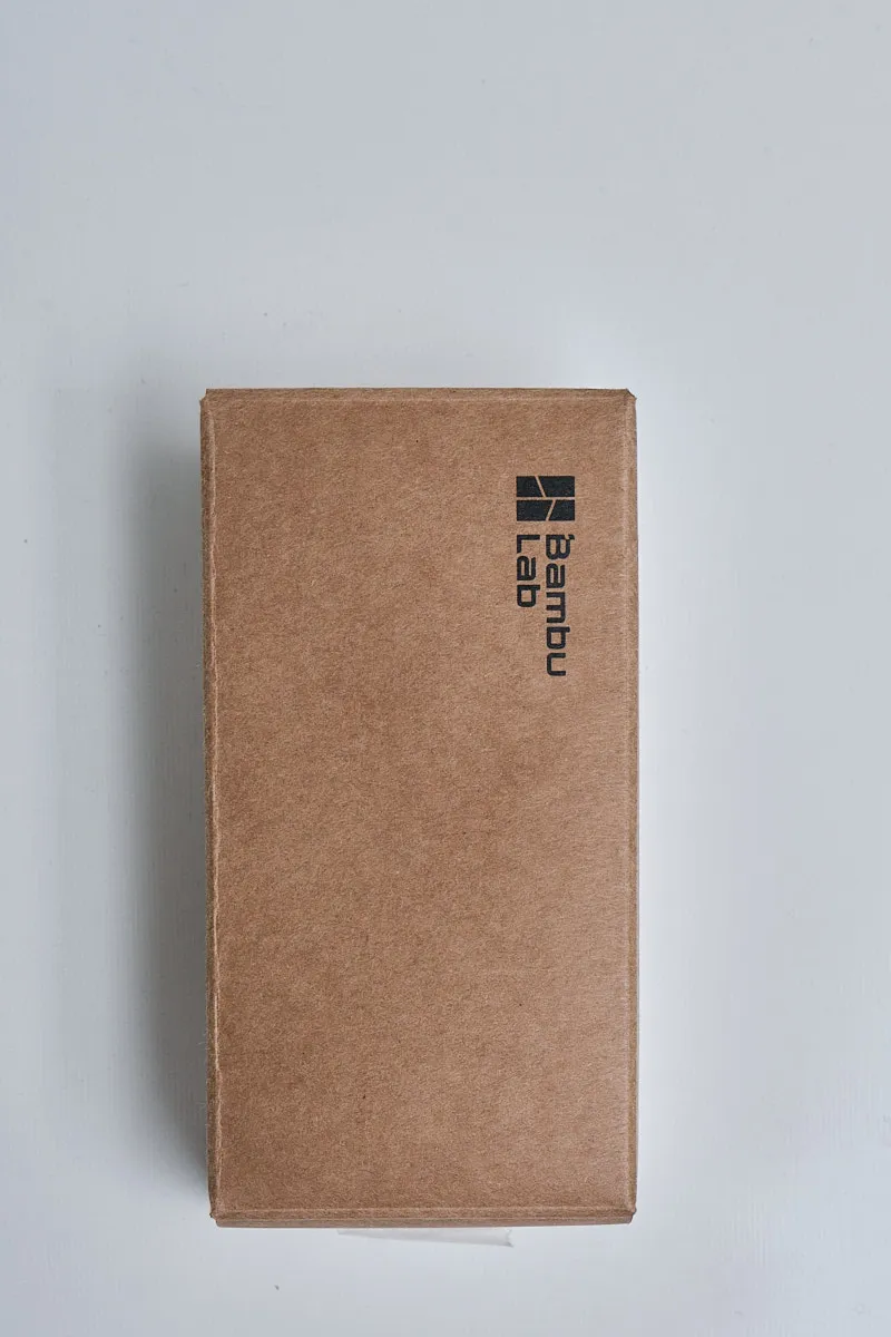 Official brown cardboard packaging box for Bambu Lab X1 series extruder unit FAE017 featuring the Bambu Lab logo.