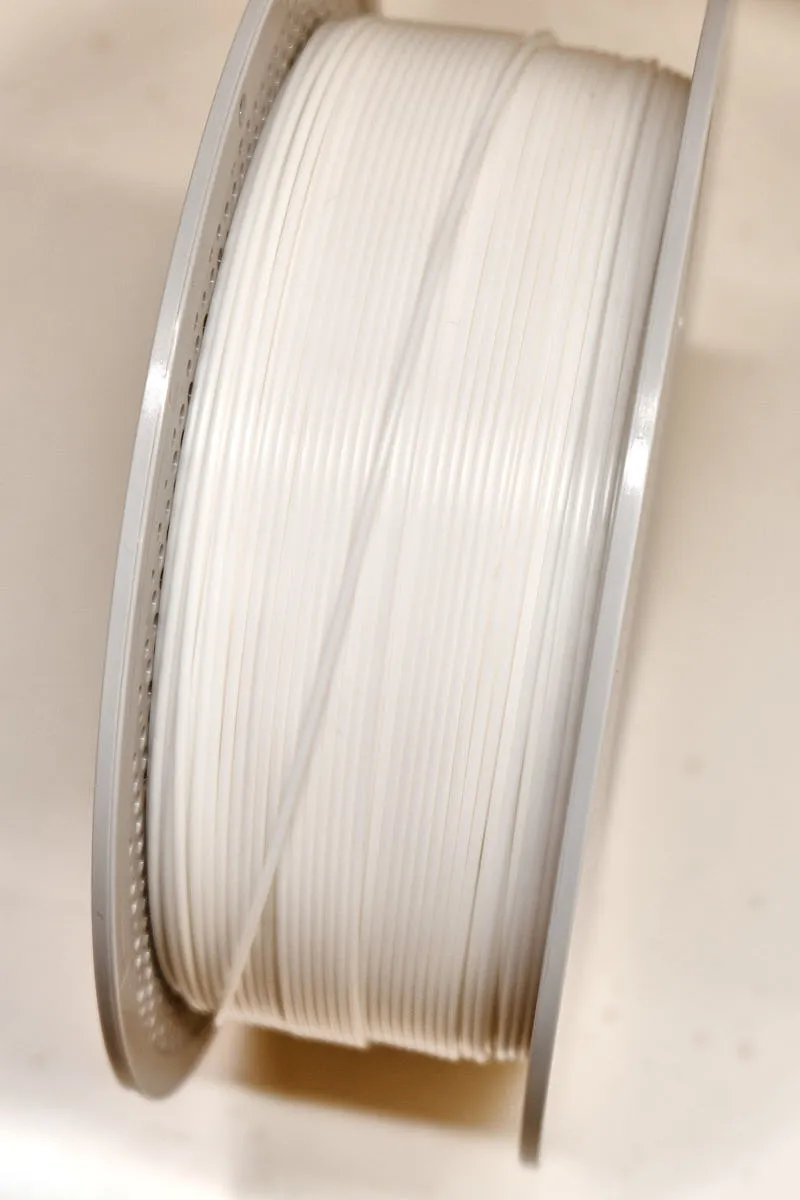 Close-up of Bambu PLA Basic jade white 10100 filament showing smooth surface and consistent diameter