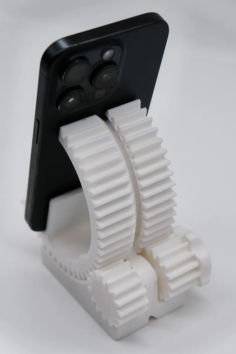 “3D-printed white phone stand made with Creality Hyper Series PLA White filament, supporting a smartphone with its rear camera visible.