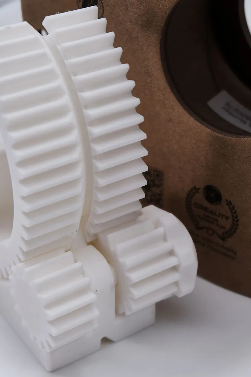 White 3D-printed phone stand back view made with Creality Hyper Series PLA White filament, with the filament spool box visible in the background.