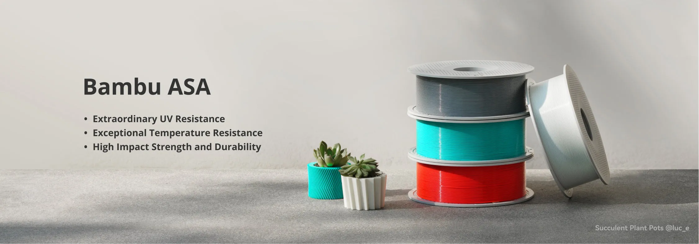 Bambu Lab ASA filament spools including ASA Gray displayed with printed samples highlighting UV and heat resistance