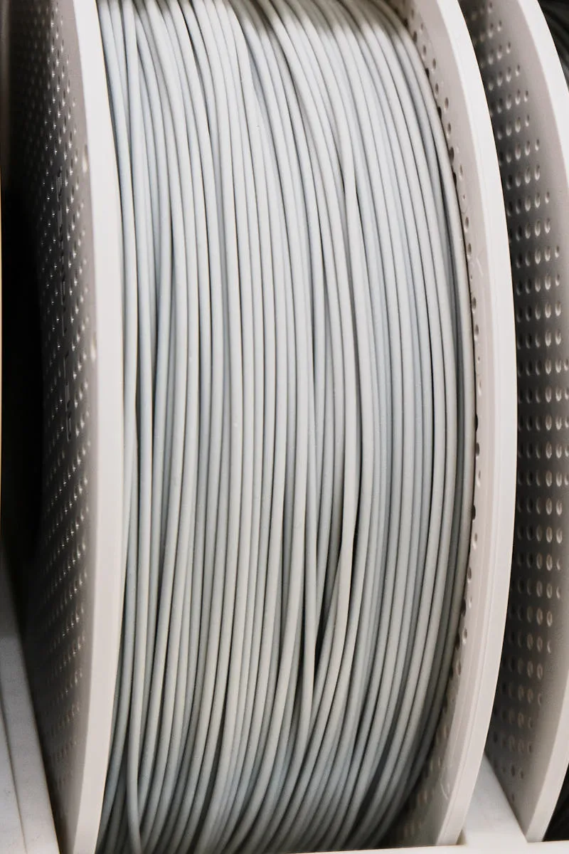 Side angle view of Bambu Lab PLA Aero gray filament spool showing tightly wound lightweight PLA filament