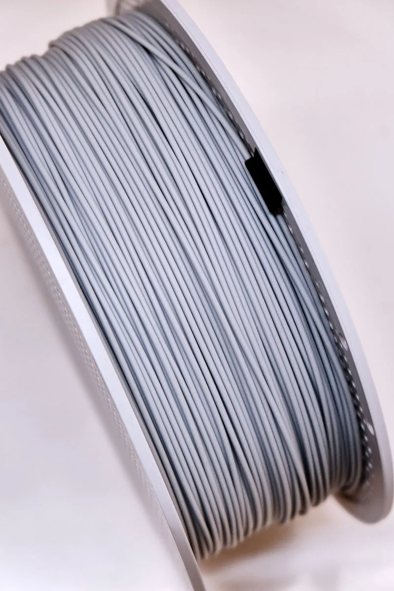 Close-up of gray PLA Aero filament showing smooth matte surface and foaming PLA texture