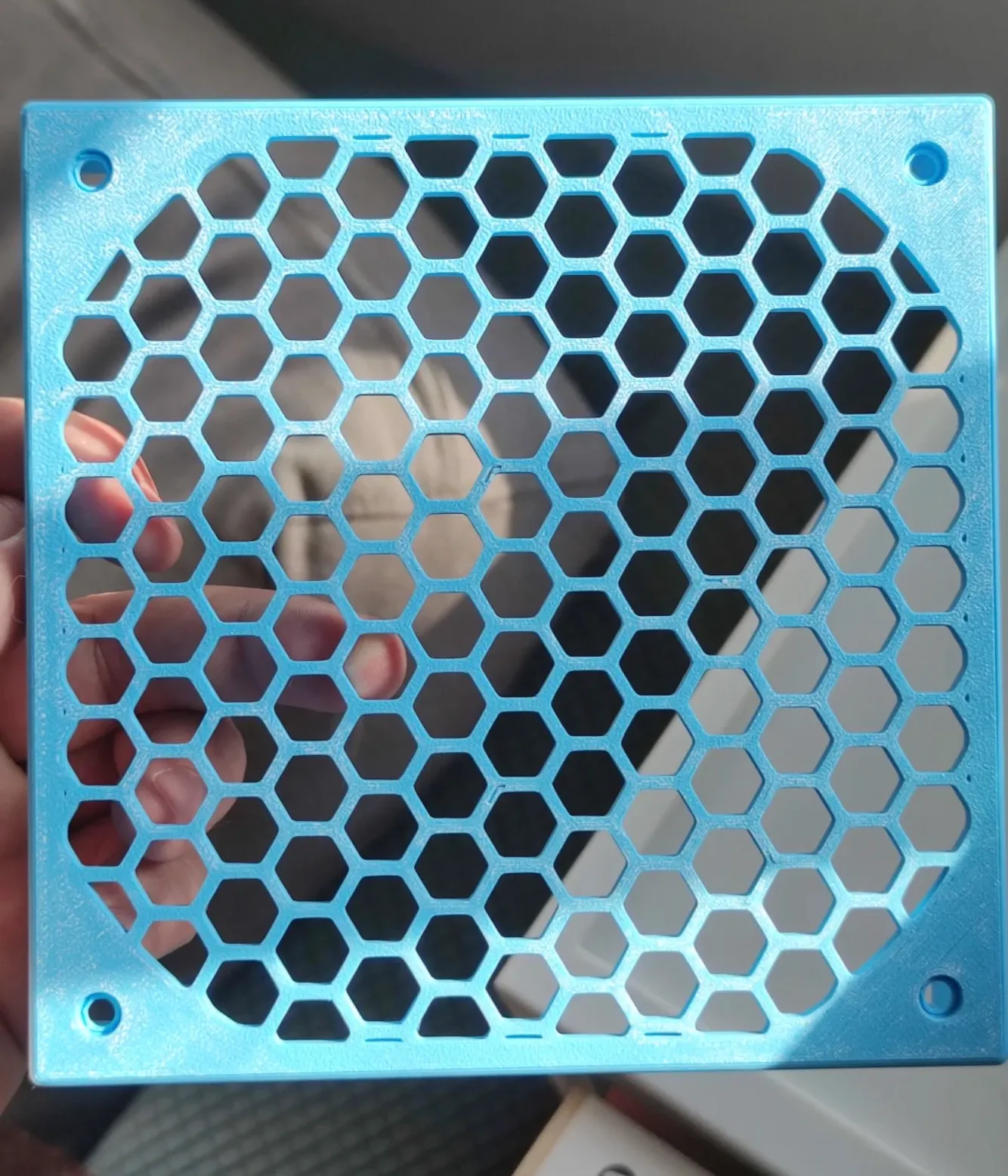 Lightweight honeycomb panel 3D printed with Bambu Lab PLA Lite Cyan filament, featuring uniform hexagonal geometry, thin walls, and clean edges