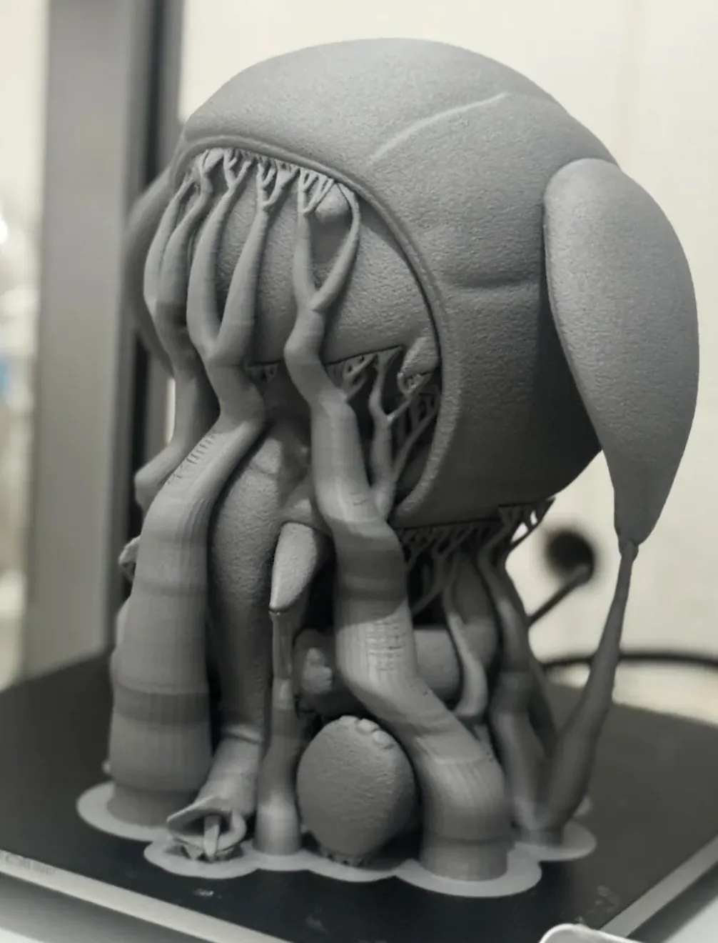 Detailed character model 3D printed with Bambu Lab PLA Lite Gray filament, featuring smooth matte surface and fine organic textures