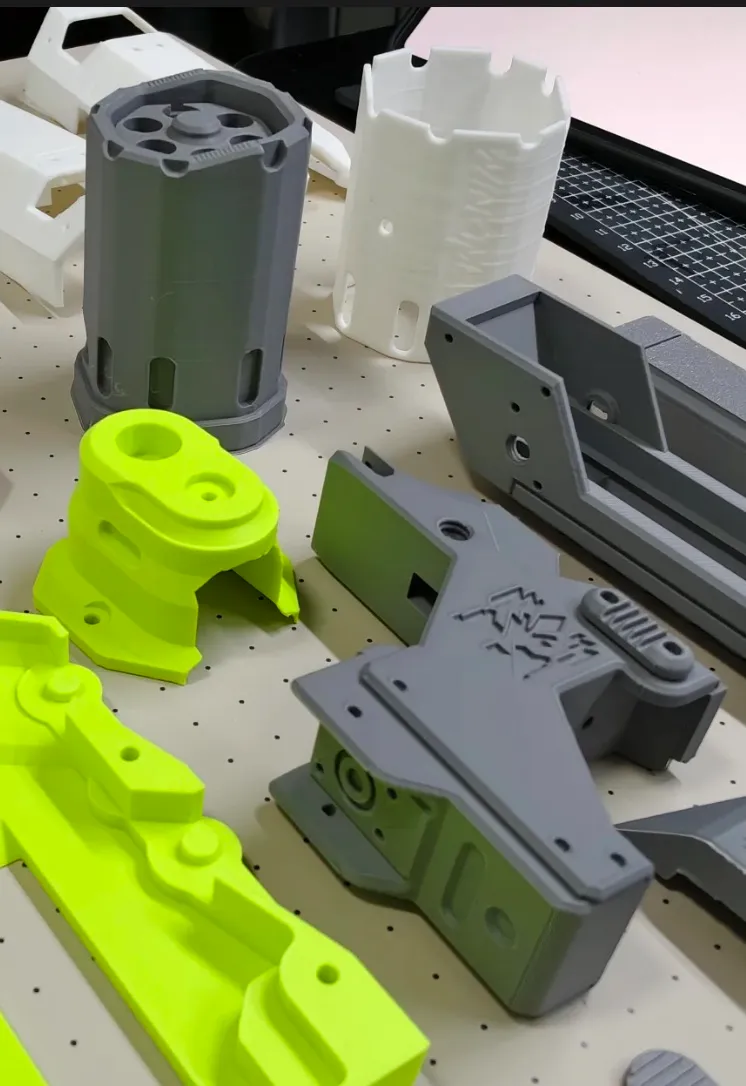 Lightweight functional components 3D printed with Bambu Lab PLA Lite Gray filament, showing clean edges, consistent wall thickness, and precision fit on a printer workbench