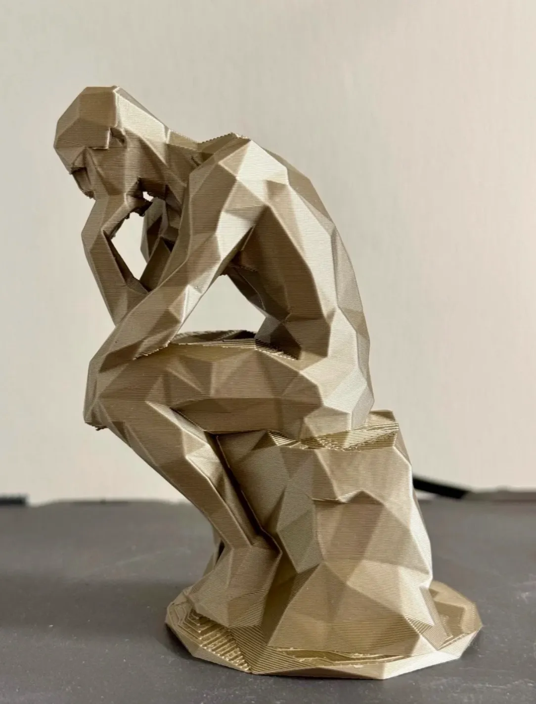 Low poly sculpture printed with Bambu Lab PLA Metal Iridium Gold Metallic filament 13400 featuring sharp geometry and metallic gold finish