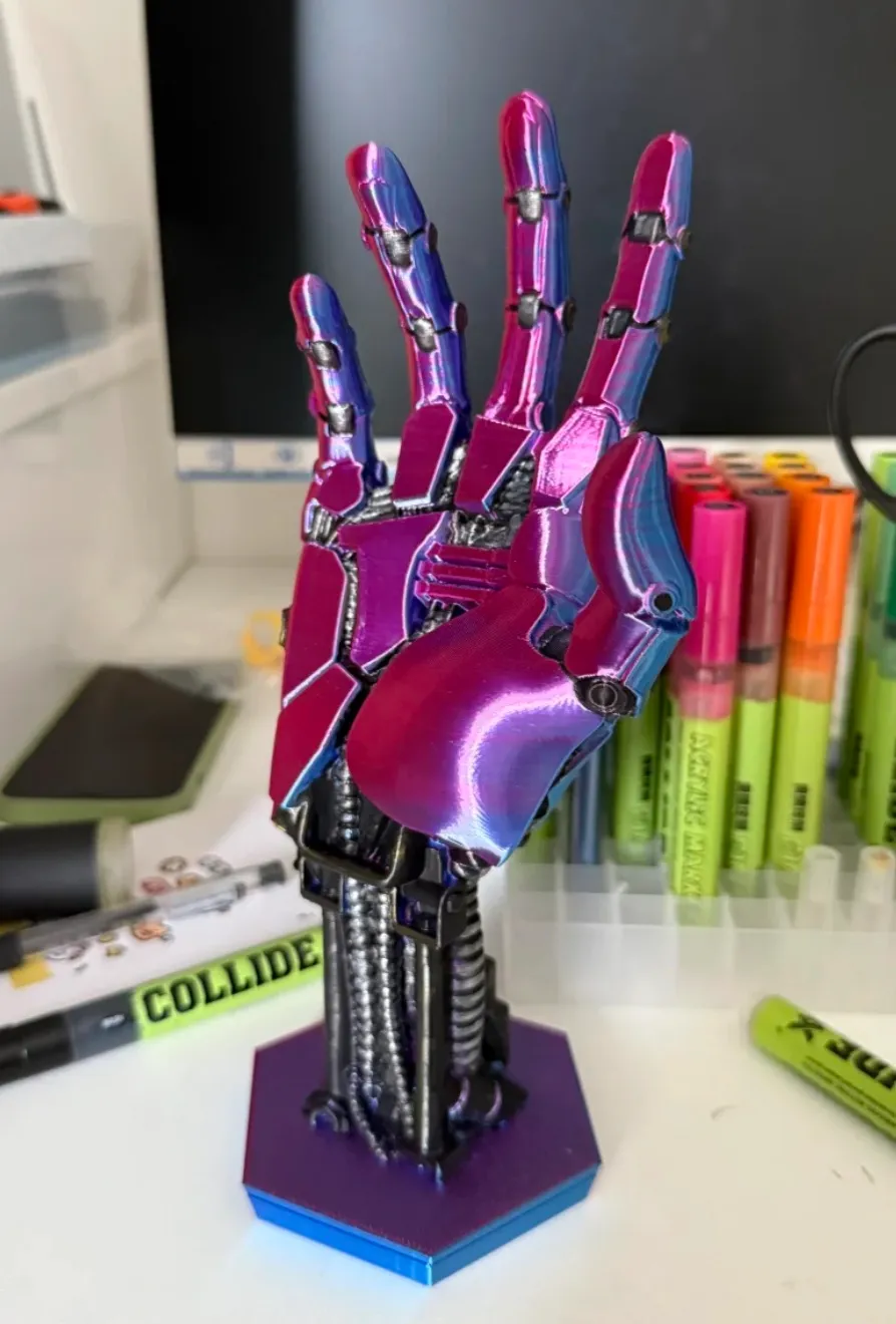 Mechanical hand sculpture 3D printed with Bambu Lab PLA Silk Aurora Purple Filament 13909, featuring metallic silk finish and aurora color shift