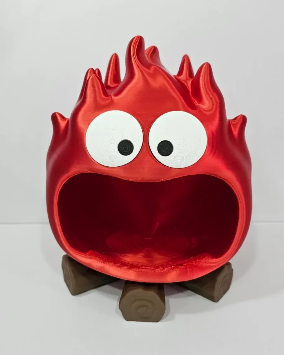 Cartoon flame container 3D printed with Bambu Lab PLA Silk+ Candy Red filament showing smooth glossy red surface
