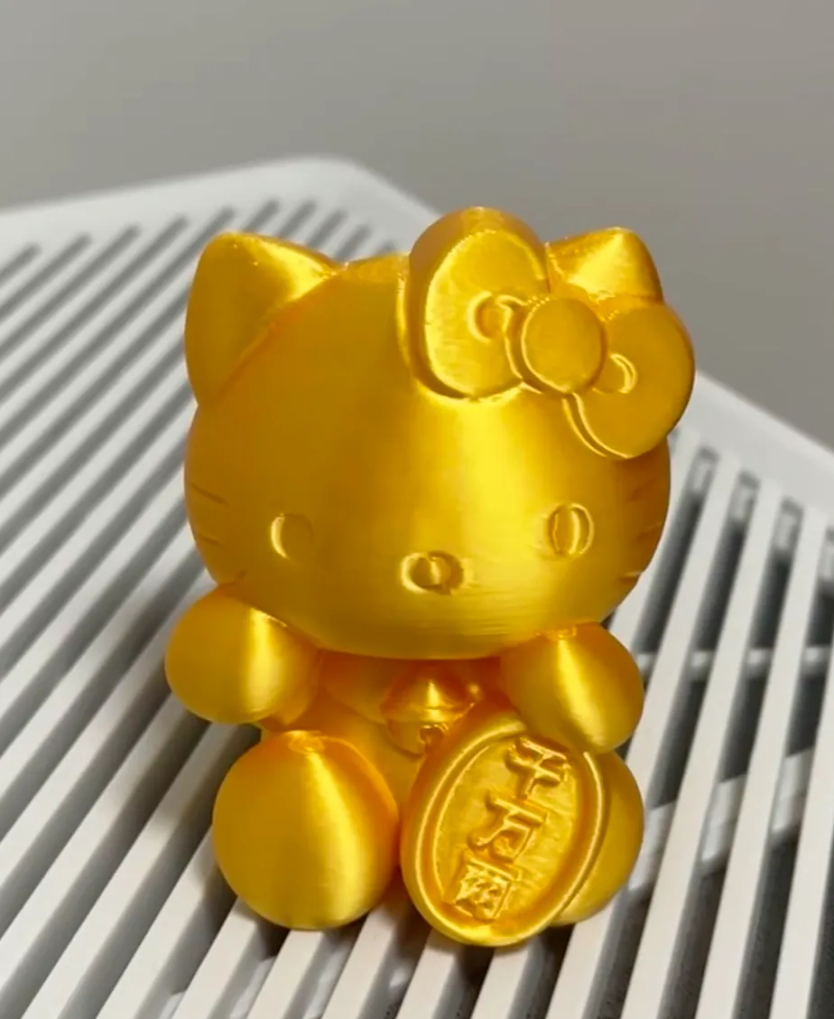 Hello Kitty figurine 3D printed with Bambu Lab PLA Silk+ Gold filament showing metallic gold silk surface