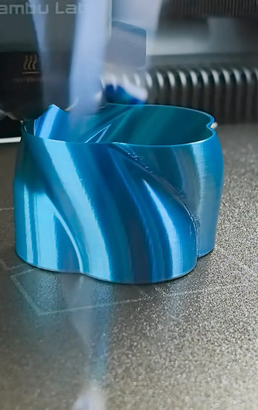 Vase being 3D printed with Bambu Lab PLA Silk Multi Color Blue Hawaii Filament 13904, showing smooth extrusion and blue gradient silk finish