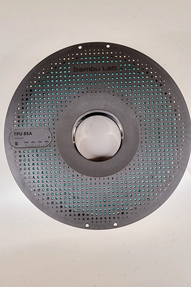Front view of Bambu Lab TPU 85A light cyan filament spool with perforated design