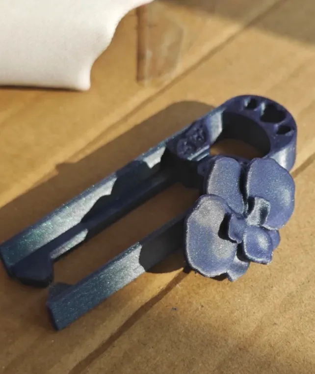 Functional printed tool part made with Bambu PLA Galaxy Nebulae filament 13504, showing blue-purple metallic galaxy shimmer and solid layer bonding