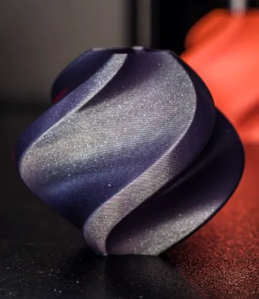 Swirl decorative model printed with Bambu PLA Galaxy Nebulae filament 13504, featuring smooth surface flow and blue-purple galaxy metallic sheen