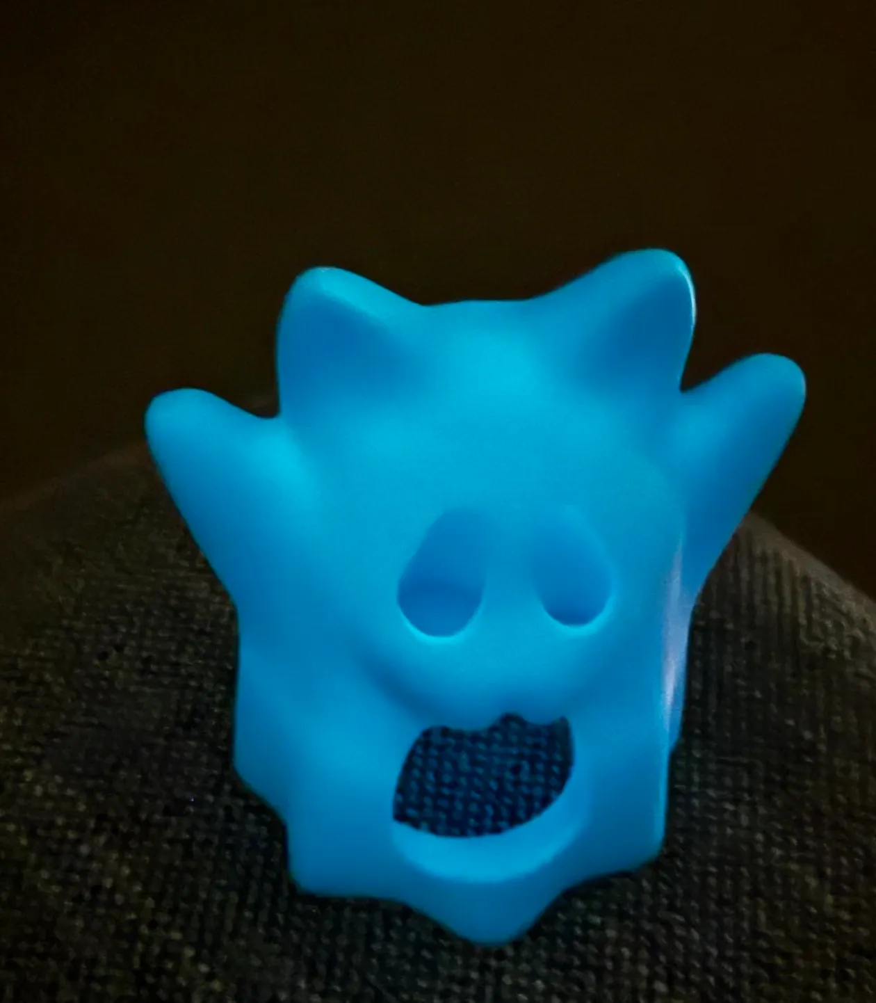 Glow blue 3D printed figure made with Bambu PLA Glow Blue filament 15600 showing surface glow under low light and direct illumination