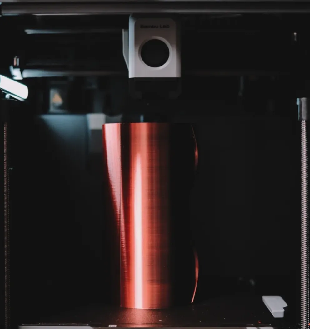Bambu Lab printer producing a cylindrical object with Bambu PLA Silk Velvet Eclipse filament showing smooth glossy velvet finish during printing