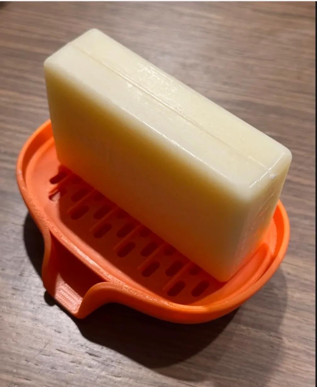 Orange 3D printed soap dish holding soap bar made with PLA Basic Orange filament 10300