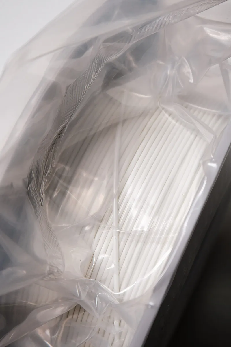 Close-up of perforated white filament spool surface for Support for PLA material