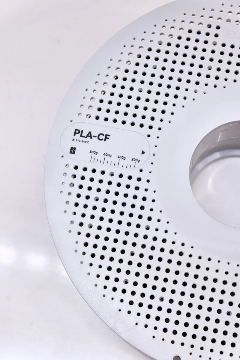 PLA-CF Lava Gray filament label on Bambu Lab spool with printing temperature information and color code 14101