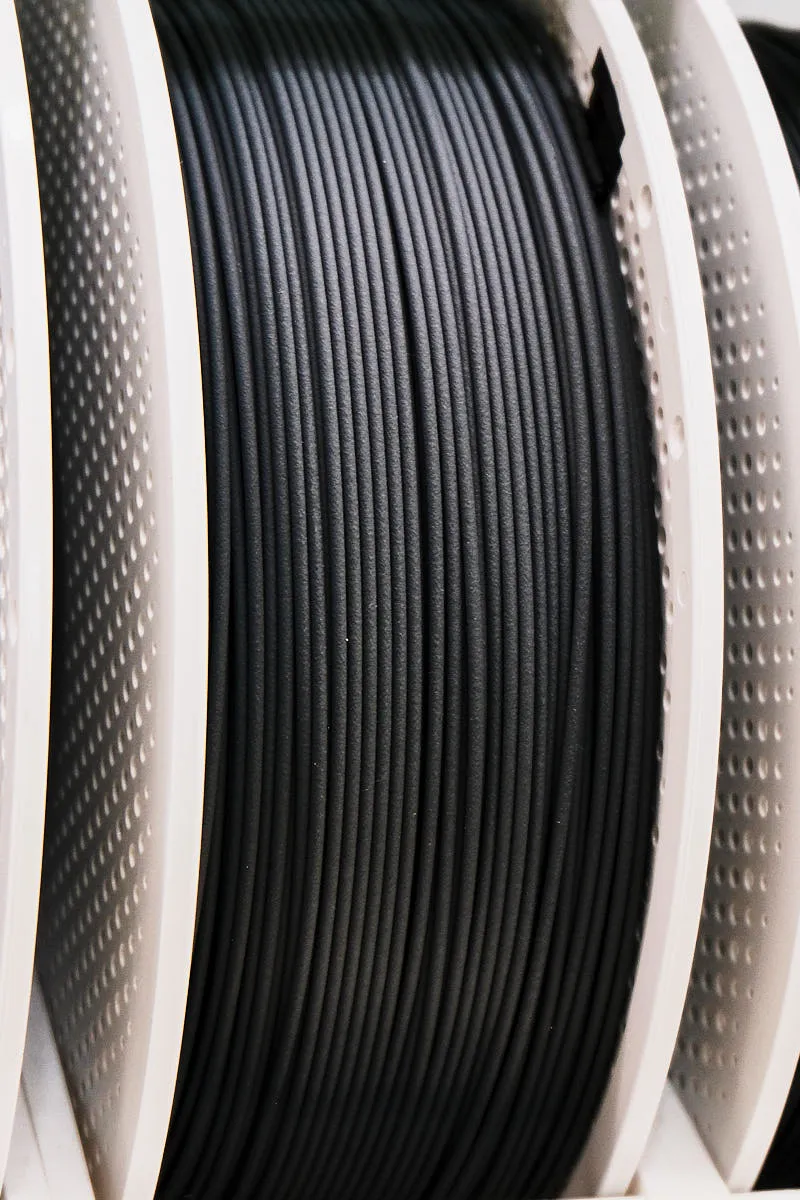 Side view of Bambu Lab PLA-CF Lava Gray filament on spool showing smooth winding and matte gray surface