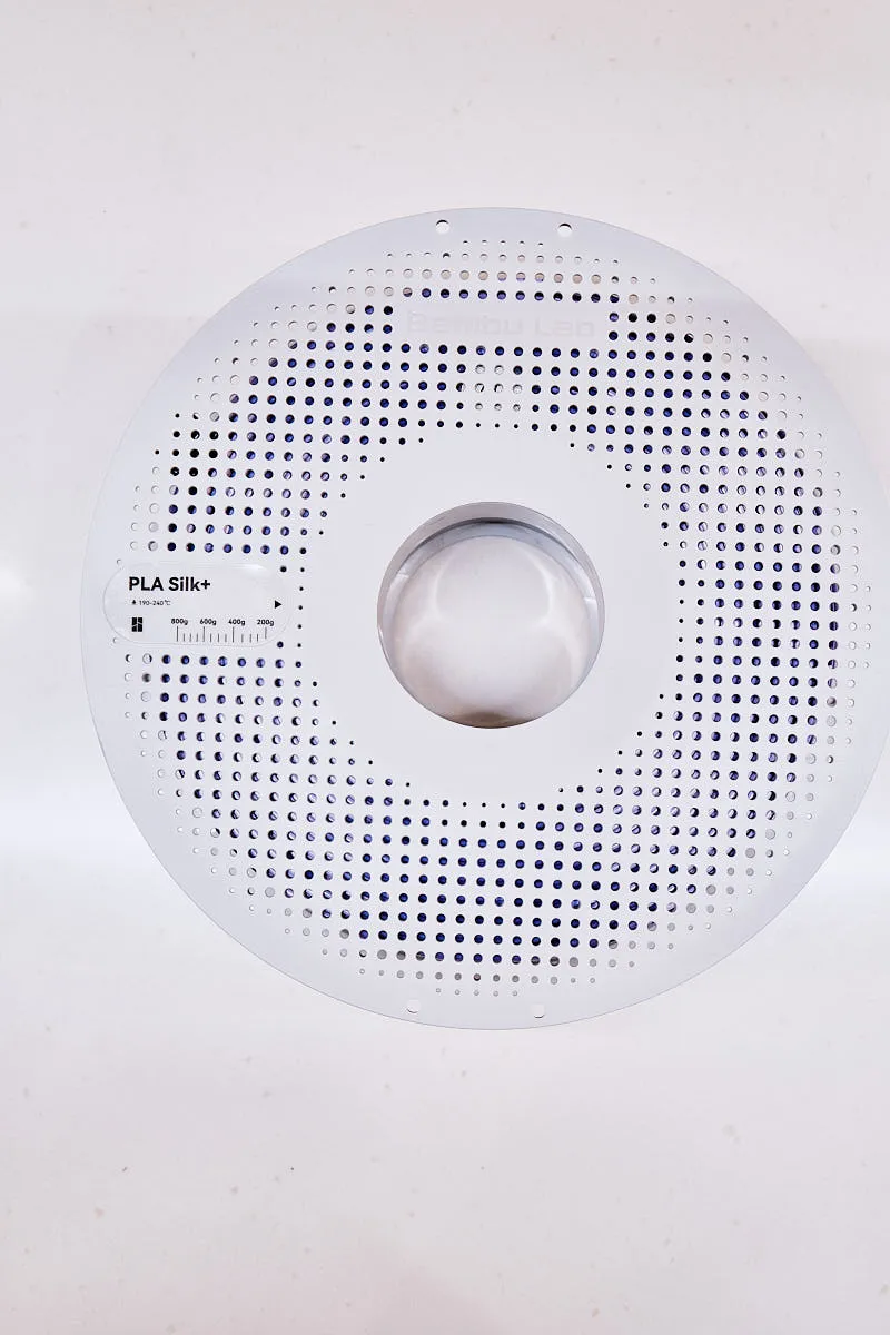 Front view of Bambu Lab PLA Silk+ Purple filament spool with perforated reel design, color code 13702