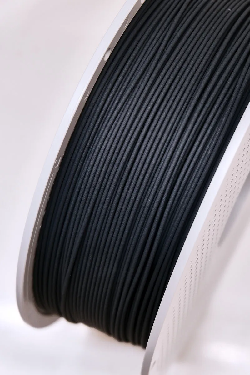 Close-up of 1.75mm PLA-CF Lava Gray filament showing matte carbon fiber texture and consistent diameter, color code 14101