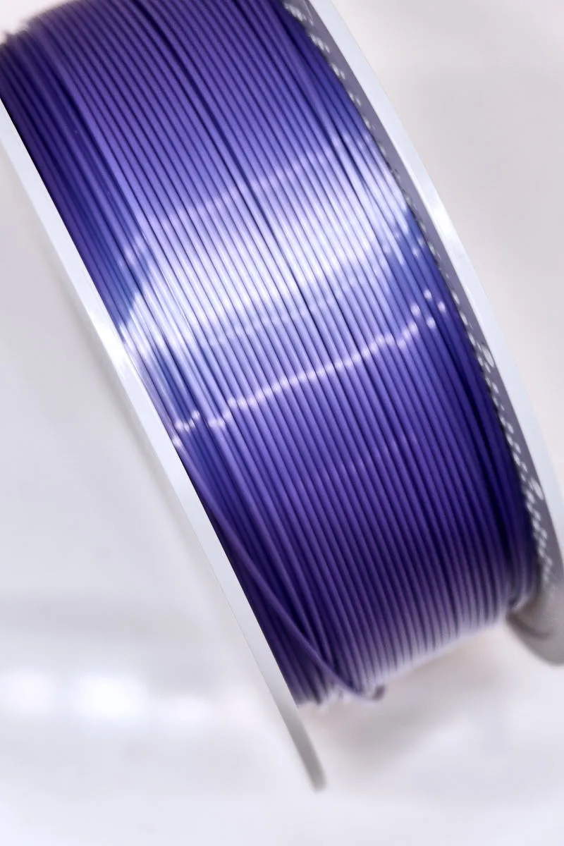 Close-up of Bambu Lab PLA Silk+ Purple filament showing smooth surface texture and silk-like gloss, color code 13702