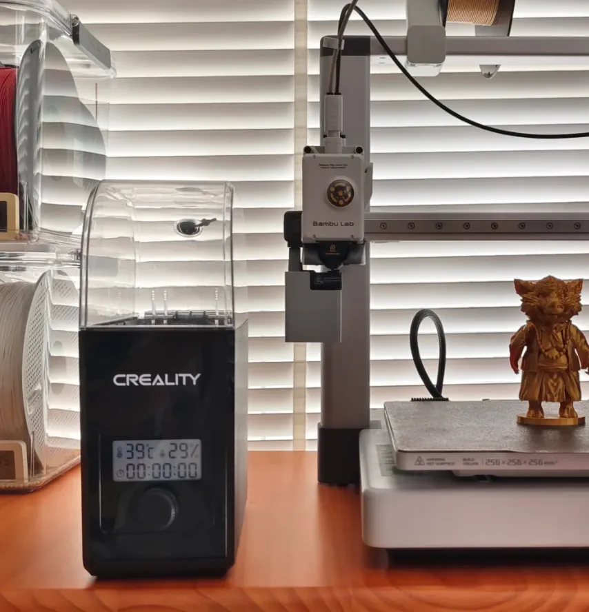 3D printer filament dryer next to printer for moisture control